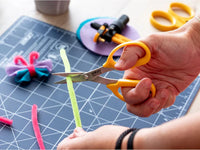 Photo of OLFA Precision Appliqué Scissors (OLF/SCS4) with stainless steel blades, ergonomic symmetrical handles, and sharp cutting edges.