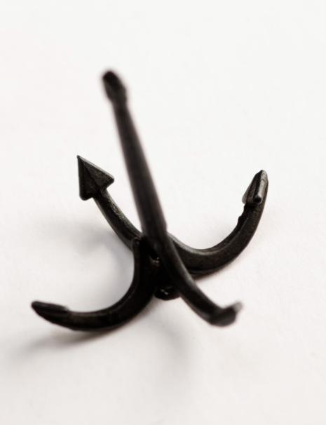 Image of Amati's 50mm Grapnel Anchor, displaying a meticulously crafted miniature replica with a traditional grapnel design, suitable for enhancing historical accuracy in model ships and nautical dioramas.