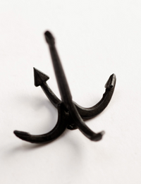 Image of Amati's 50mm Grapnel Anchor, displaying a meticulously crafted miniature replica with a traditional grapnel design, suitable for enhancing historical accuracy in model ships and nautical dioramas.