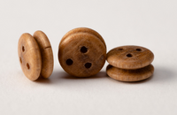 Image of Amati's B4049,07 7mm Walnut Deadeyes, showcasing a set of finely crafted walnut miniature deadeyes, ideal for adding realistic and historical rigging details to model ships.