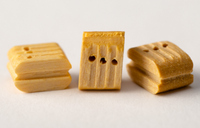 Image of Amati's B4089,07 7mm Boxwood Triple Blocks, showcasing 20 high-quality, finely detailed pieces ideal for complex model ship rigging systems.