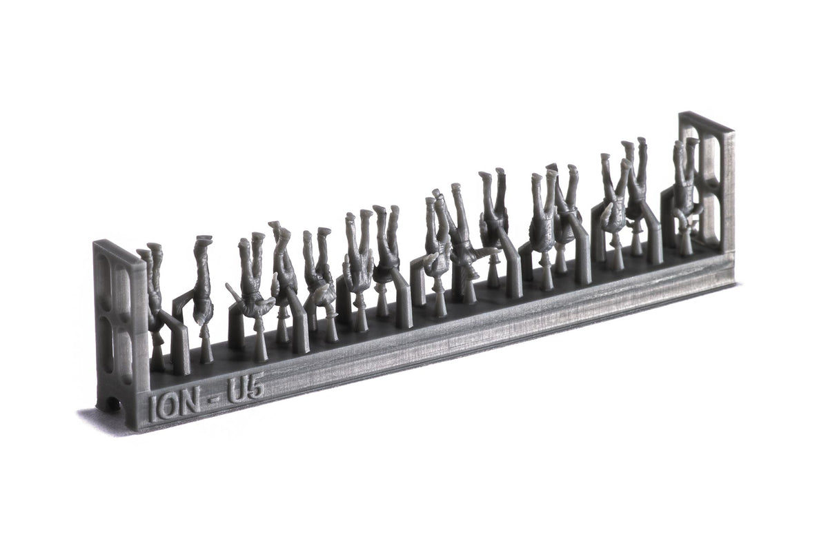 Photo of 74 finely detailed 3D-printed resin figures of US Navy WWII personnel in 1:250 scale, posed in active and relaxed positions for ship modeling.