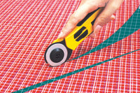 Photo of OLFA Quick-Change Advanced Rotary Cutter 45mm with ergonomic handle and safety blade guard.