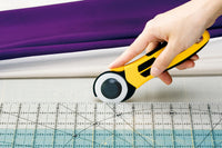 Photo of OLFA Quick-Change Advanced Rotary Cutter 45mm with ergonomic handle and safety blade guard.
