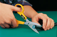 Photo of OLFA Powergrip Scissors 55mm with ultra-sharp stainless steel serrated blades and ergonomic handle, designed for precision cutting on various materials.