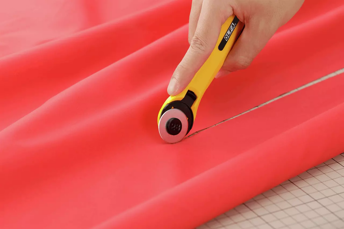 Photo of OLFA Quick-Change Rotary Cutter 28mm with ergonomic contoured handle and quick-change blade system, designed for precision cutting.