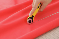 Photo of OLFA Quick-Change Rotary Cutter 28mm with ergonomic contoured handle and quick-change blade system, designed for precision cutting.