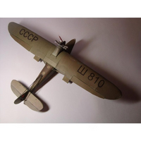 A model of a vintage Soviet biplane, likely a Zlinska Z-25, painted in a muted olive drab green with black Cyrillic markings 'CCCP' and 'Ш 810'.