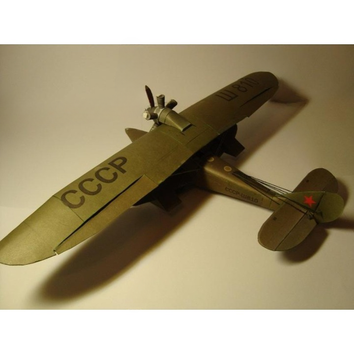 A vintage-style model airplane with olive drab green wings and fuselage, featuring 'CCCP' markings and a red star on the tail, photographed on a plain light background.