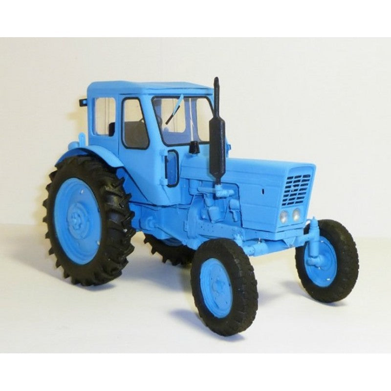 A blue tractor model with black tires, photographed on a plain light background.