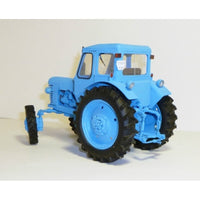 A light blue model tractor with black tires, shown from a three-quarters angle against a plain off-white background.
