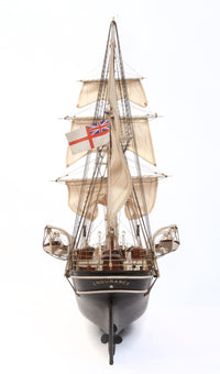 Photo of OcCre Endurance 1:70 wooden model ship kit with sails, nameplate, and detailed wooden construction