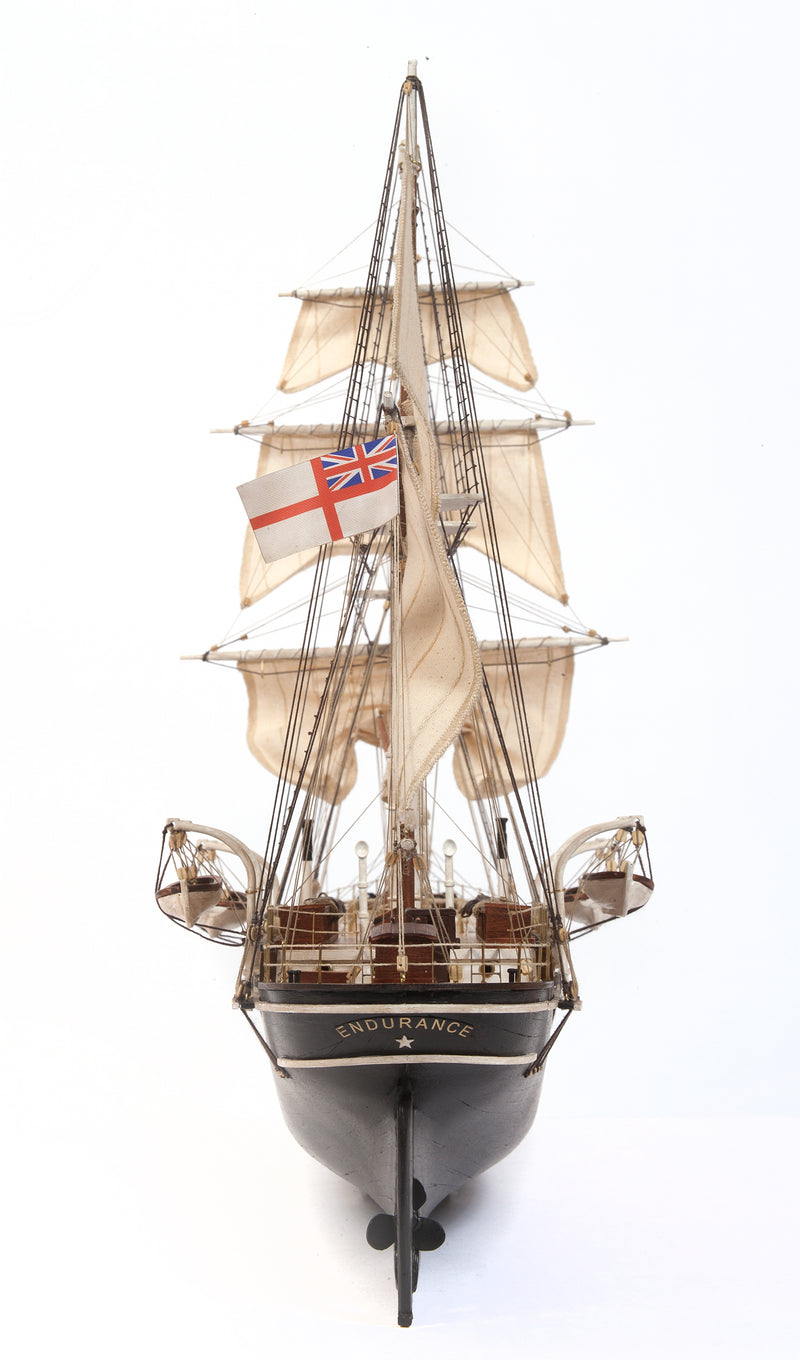 Photo of OcCre Endurance 1:70 wooden model ship kit with sails, nameplate, and detailed wooden construction
