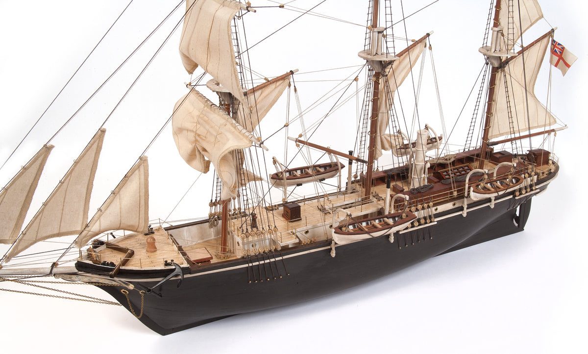 Photo of OcCre Endurance 1:70 wooden model ship kit with sails, nameplate, and detailed wooden construction