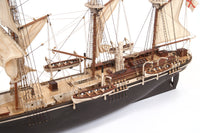 Photo of OcCre Endurance 1:70 wooden model ship kit with sails, nameplate, and detailed wooden construction