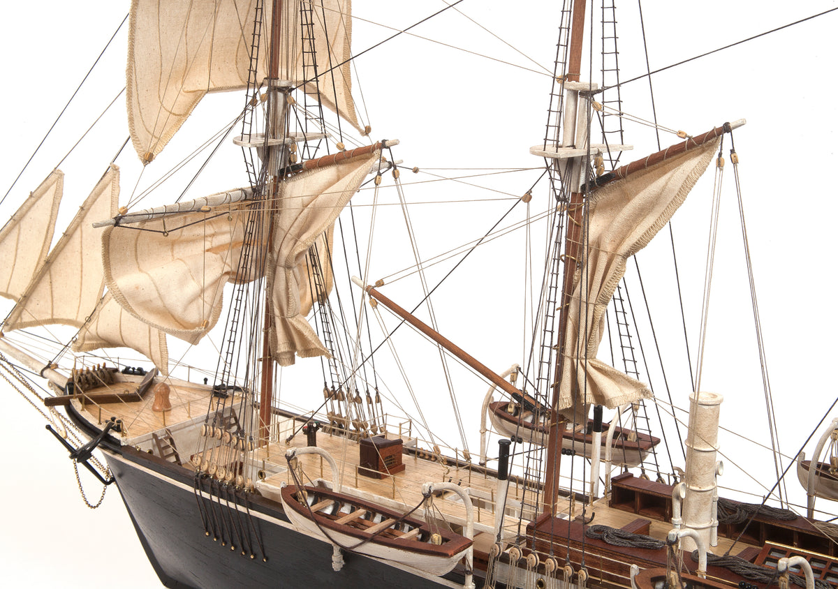 Photo of OcCre Endurance 1:70 wooden model ship kit with sails, nameplate, and detailed wooden construction