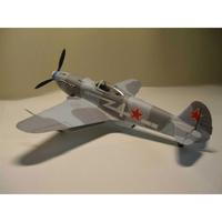 A model of a Soviet fighter plane, likely a MiG-23, painted in a gray camouflage pattern with red star insignias on the wings and tail, displayed on a neutral surface.