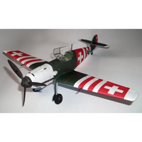 A model Swiss Air Force fighter plane, likely a Fieseler Fi 110, featuring a dark green fuselage, white nose and tail sections, and red-and-white striped wings with white Swiss crosses.