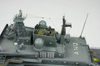 A detailed model of a gray military aircraft carrier deck, featuring radar domes, antennas, and the aircraft landing gear marked with the number A1412, set against a plain light gray background.