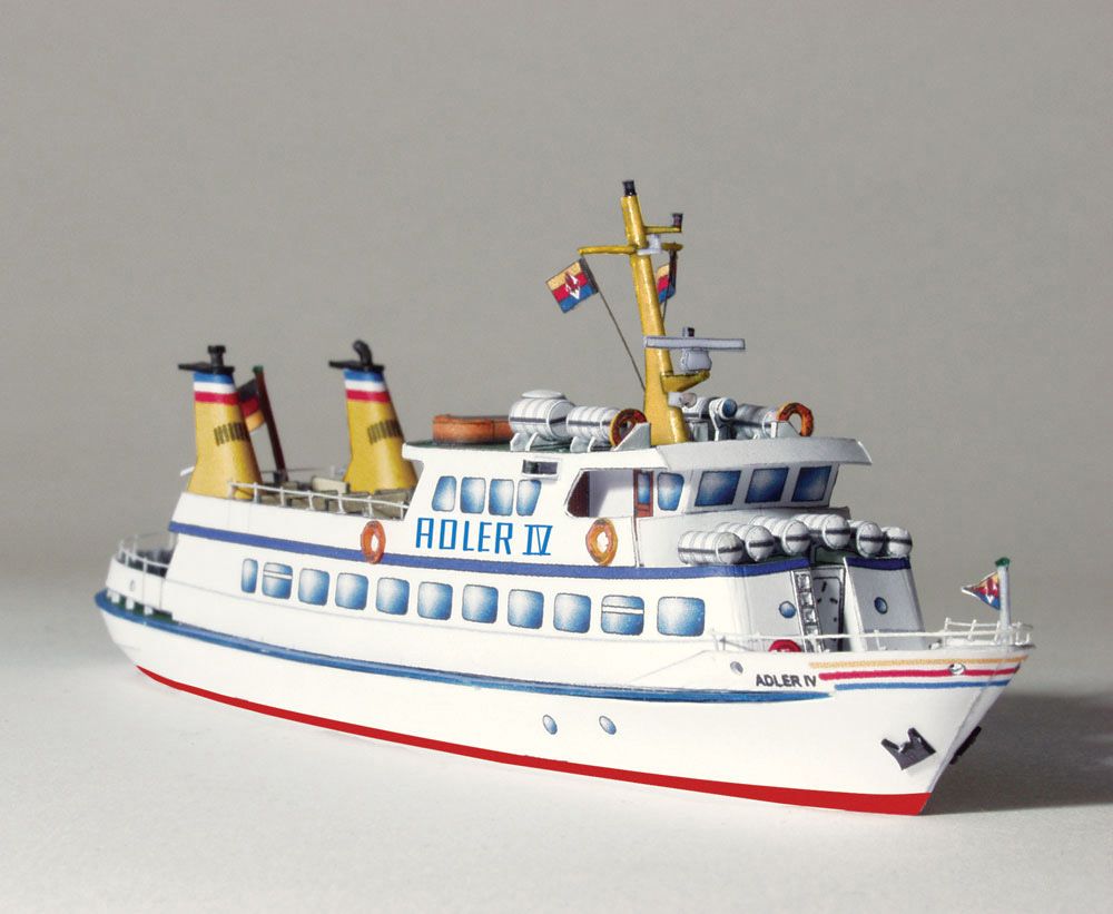 Photo of the HMV Adler IV Passenger Ship Card Model Kit in 1:250 scale showing detailed paper parts and finished ship model.