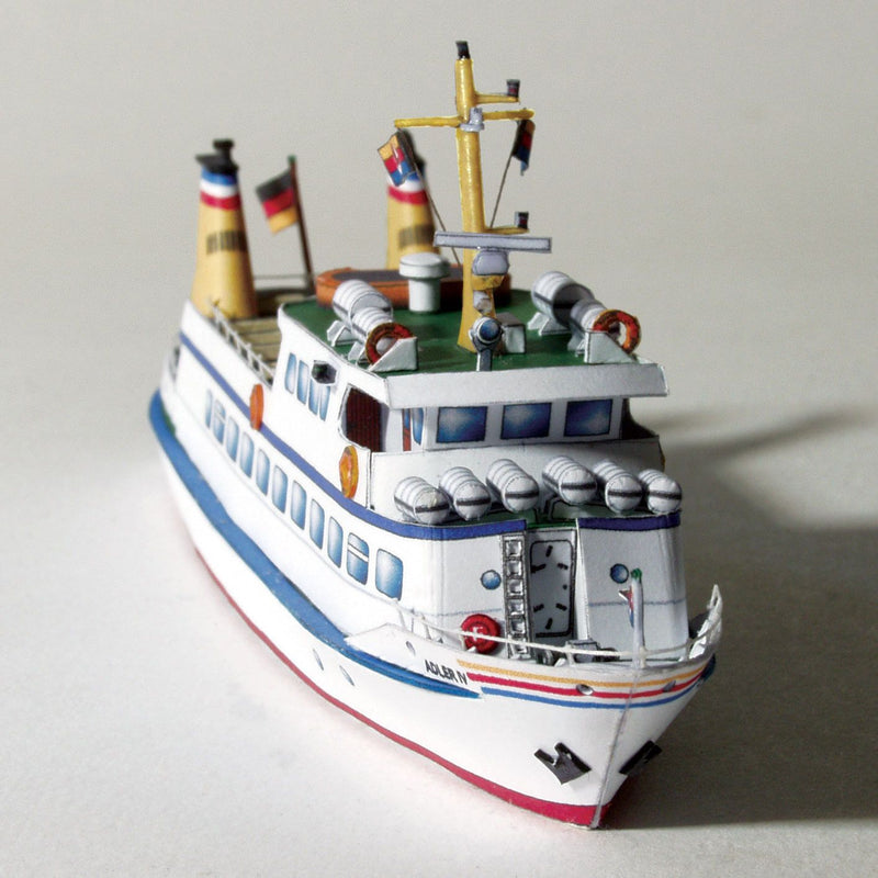 Photo of the HMV Adler IV Passenger Ship Card Model Kit in 1:250 scale showing detailed paper parts and finished ship model.