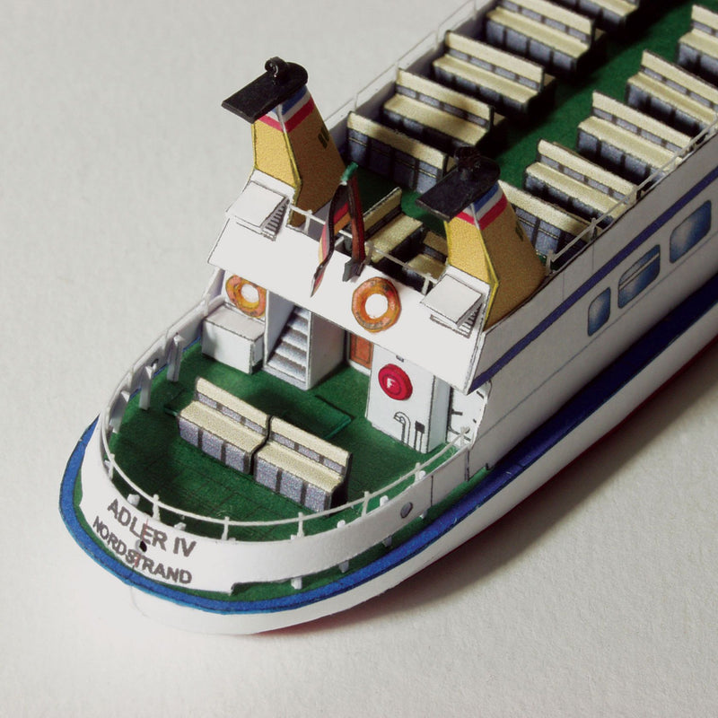 Photo of the HMV Adler IV Passenger Ship Card Model Kit in 1:250 scale showing detailed paper parts and finished ship model.