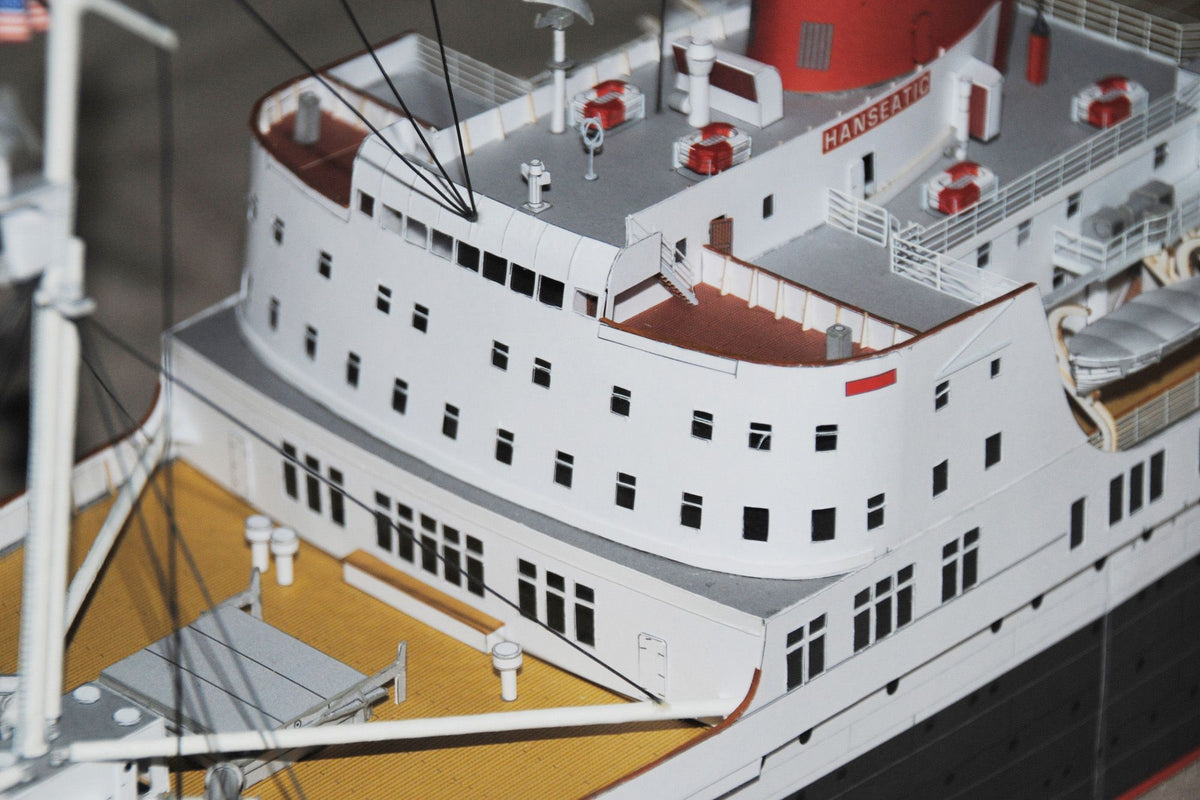 Photo of HMV TS Hanseatic 1/250 card model kit showing detailed superstructure, lifeboats, and elegant hull design by Peter Brandt