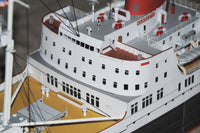 Photo of HMV TS Hanseatic 1/250 card model kit showing detailed superstructure, lifeboats, and elegant hull design by Peter Brandt