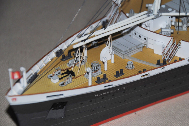 Photo of HMV TS Hanseatic 1/250 card model kit showing detailed superstructure, lifeboats, and elegant hull design by Peter Brandt