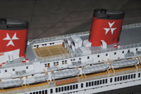Photo of HMV TS Hanseatic 1/250 card model kit showing detailed superstructure, lifeboats, and elegant hull design by Peter Brandt