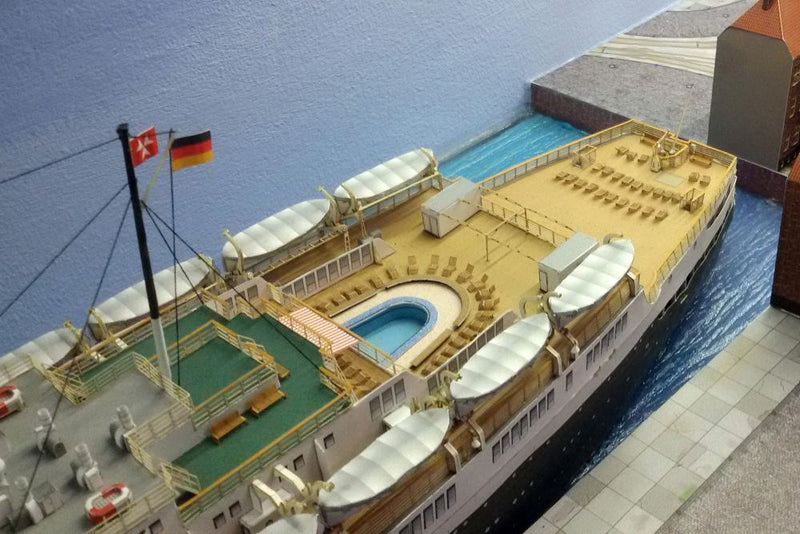 Photo of HMV TS Hanseatic 1/250 card model kit showing detailed superstructure, lifeboats, and elegant hull design by Peter Brandt