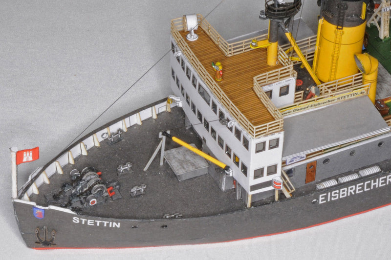 Photo of HMV Steam Icebreaker STETTIN card model kit 1:250 showing detailed paper model of the German museum ship with masts, rigging, and bridge interior