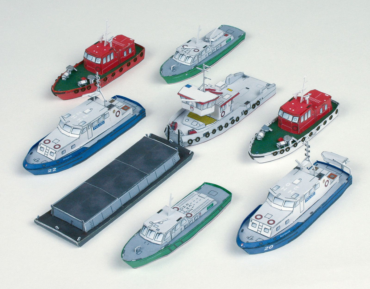 Photo of HMV Modern Harbor Boats 1/250 card model kit showing eight detailed paper ships including customs boats, tugboat, pilot cutters, and police boats.