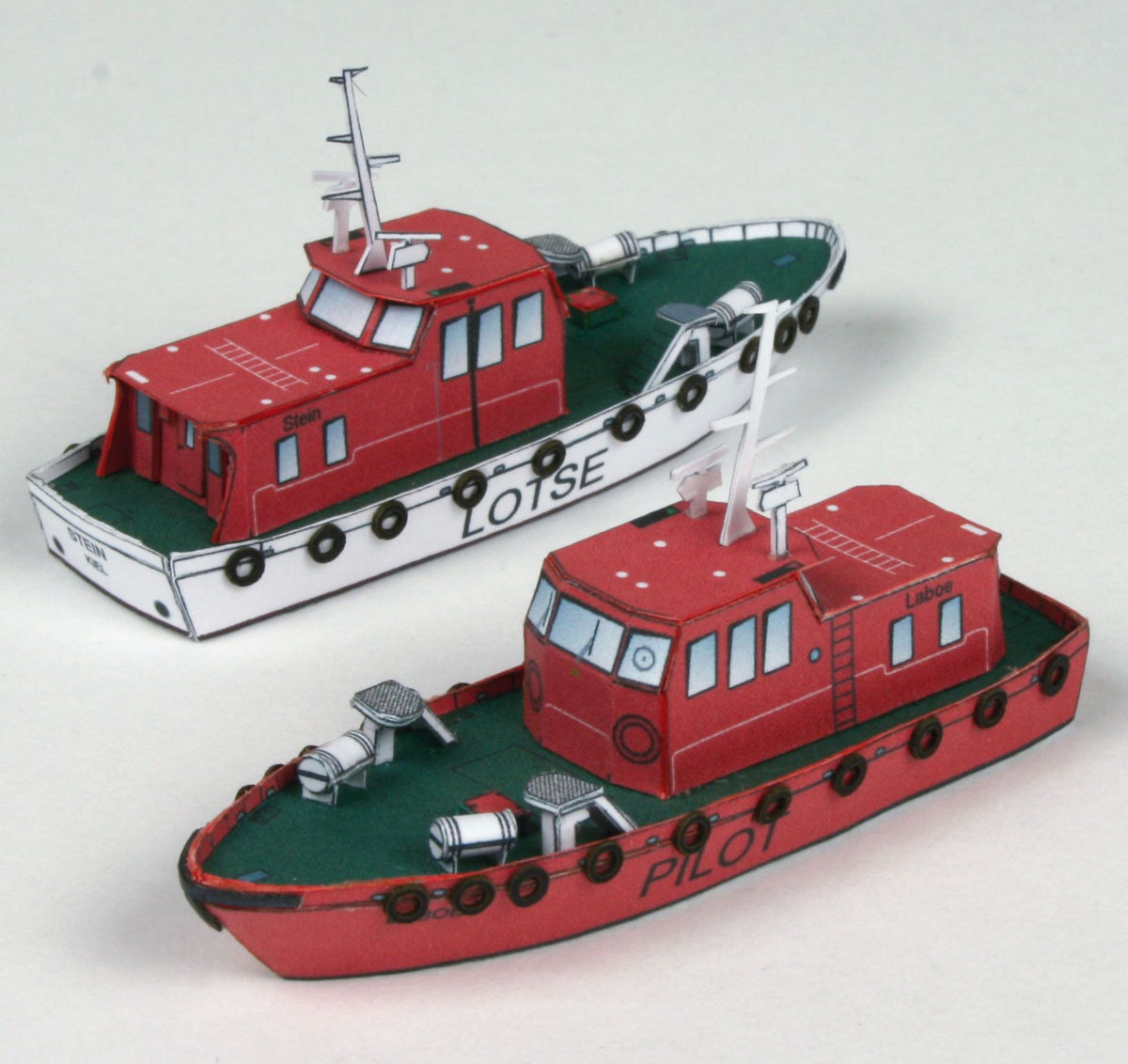 Photo of HMV Modern Harbor Boats 1/250 card model kit showing eight detailed paper ships including customs boats, tugboat, pilot cutters, and police boats.