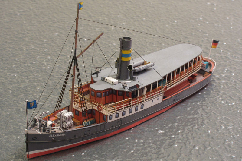 Photo of HMV Passenger Steamer Alexandra 1/250 card model kit showing detailed decks, lifeboat, and superstructure.