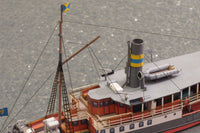 Photo of HMV Passenger Steamer Alexandra 1/250 card model kit showing detailed decks, lifeboat, and superstructure.