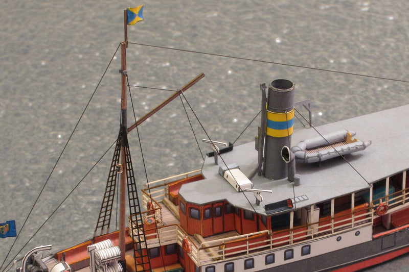 Photo of HMV Passenger Steamer Alexandra 1/250 card model kit showing detailed decks, lifeboat, and superstructure.
