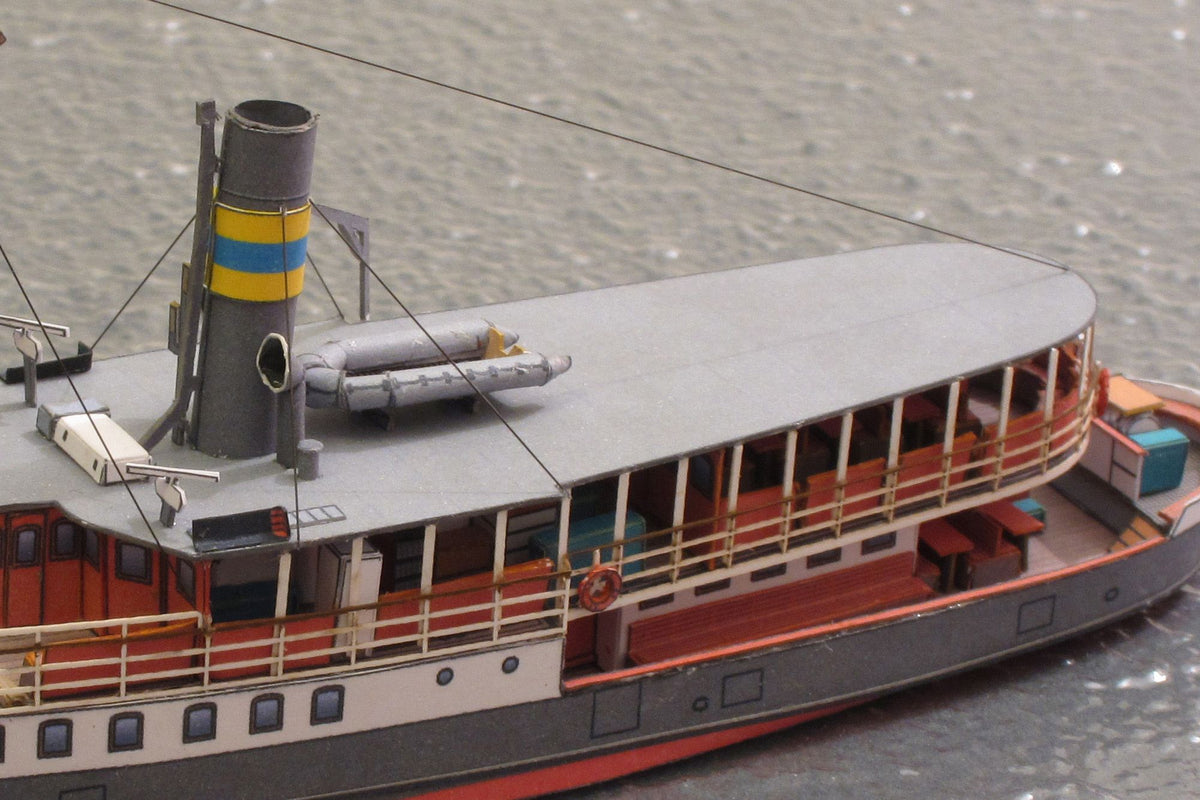 Photo of HMV Passenger Steamer Alexandra 1/250 card model kit showing detailed decks, lifeboat, and superstructure.