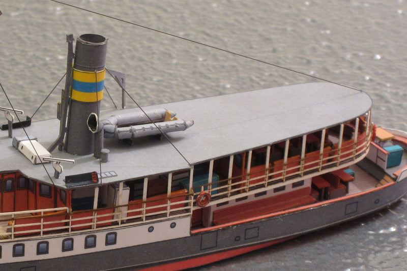 Photo of HMV Passenger Steamer Alexandra 1/250 card model kit showing detailed decks, lifeboat, and superstructure.