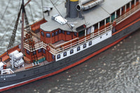 Photo of HMV Passenger Steamer Alexandra 1/250 card model kit showing detailed decks, lifeboat, and superstructure.