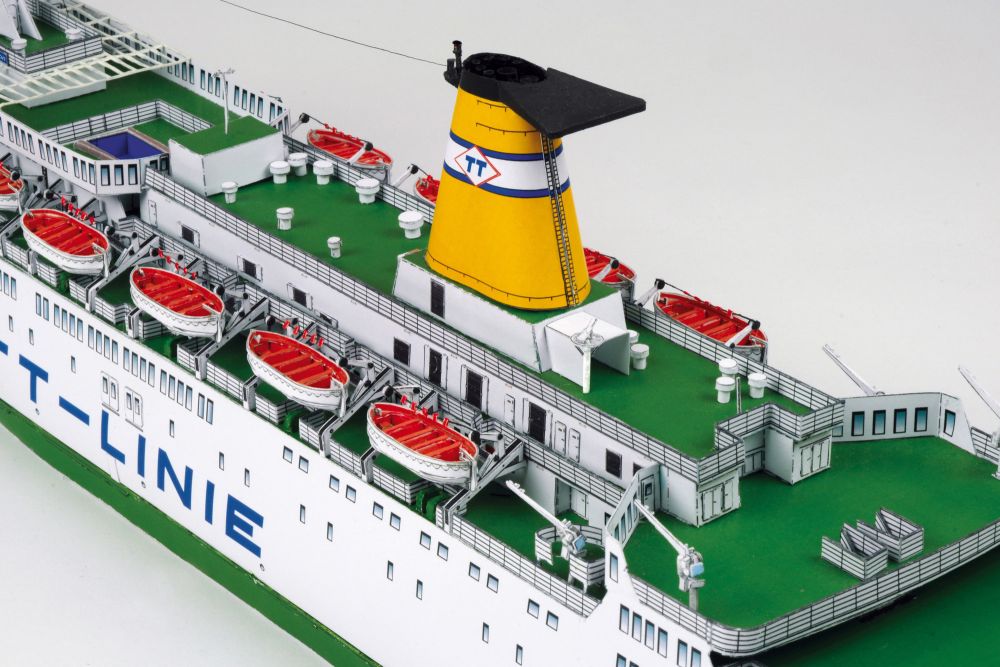 Photo of HMV TT-Line Ferry Nils Holgersson / Peter Pan 1:250 scale paper model kit by HMV, showing detailed decks, lifeboats, and ferry structure.