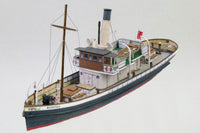 Photo of the HMV 1/250 scale Steam Tug Waratah paper model kit showing detailed deck design, filigree masts, and bridge interior.