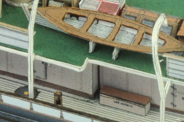 Photo of the HMV 1/250 scale Steam Tug Waratah paper model kit showing detailed deck design, filigree masts, and bridge interior.