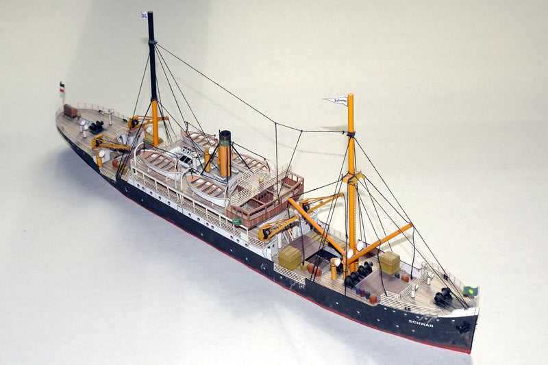 Photo of HMV Steamer Schwan II card model kit 1:250 showing detailed paper parts and assembled model of the 1907 German passenger and freight ship.