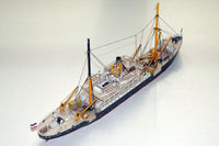 Photo of HMV Steamer Schwan II card model kit 1:250 showing detailed paper parts and assembled model of the 1907 German passenger and freight ship.