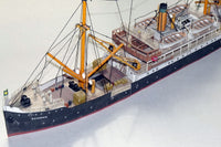 Photo of HMV Steamer Schwan II card model kit 1:250 showing detailed paper parts and assembled model of the 1907 German passenger and freight ship.