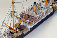 Photo of HMV Steamer Schwan II card model kit 1:250 showing detailed paper parts and assembled model of the 1907 German passenger and freight ship.