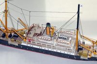 Photo of HMV Steamer Schwan II card model kit 1:250 showing detailed paper parts and assembled model of the 1907 German passenger and freight ship.