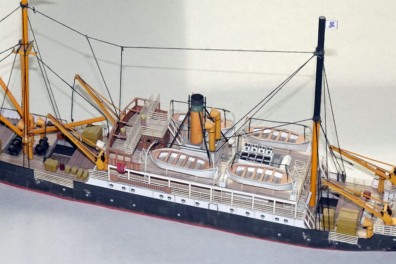 Photo of HMV Steamer Schwan II card model kit 1:250 showing detailed paper parts and assembled model of the 1907 German passenger and freight ship.