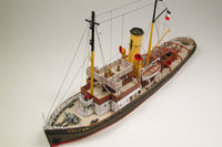 Photo of HMV Merkur and Vulkan 1/250 scale tugboat card model kit showing detailed steam tugs with printed parts and maritime accessories.